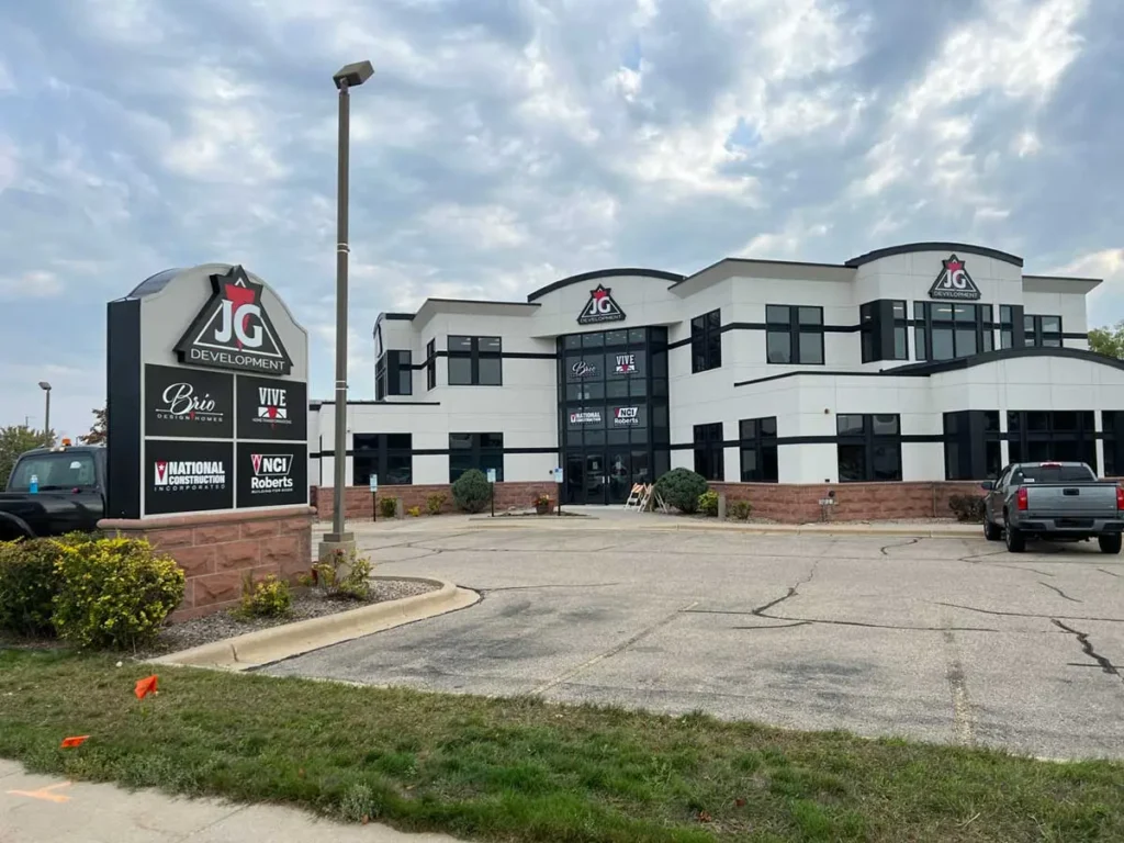 white office building with dark windows and signs