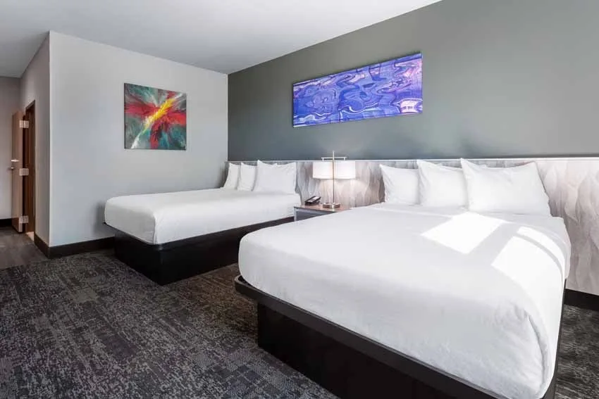 Hotel of the Arts Baymont Inn & Suites Neutral palette accented with pops of color