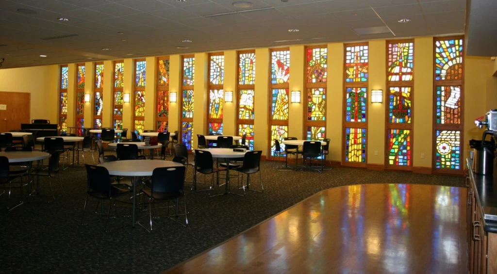 Wisconsin Lutheran Chapel & Student Center - Fellowship space with stained glass windows