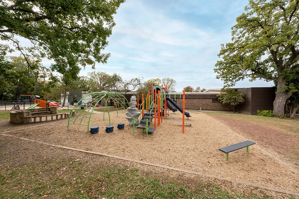Colorful playground next to brown brick building