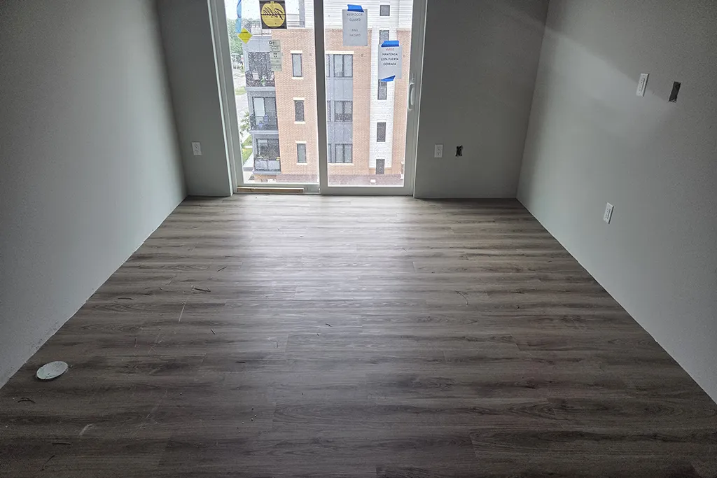 Interior of Park Lofts apartment with sliding doors and new woodgrain flooring